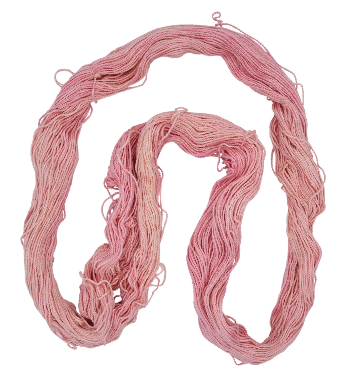 Himalayan Salt yarn displayed in a spread-out hank — DK weight hand-dyed Pima cotton with a delicate mix of peach and pink shades, featuring tonal variation and defined 2-ply twist