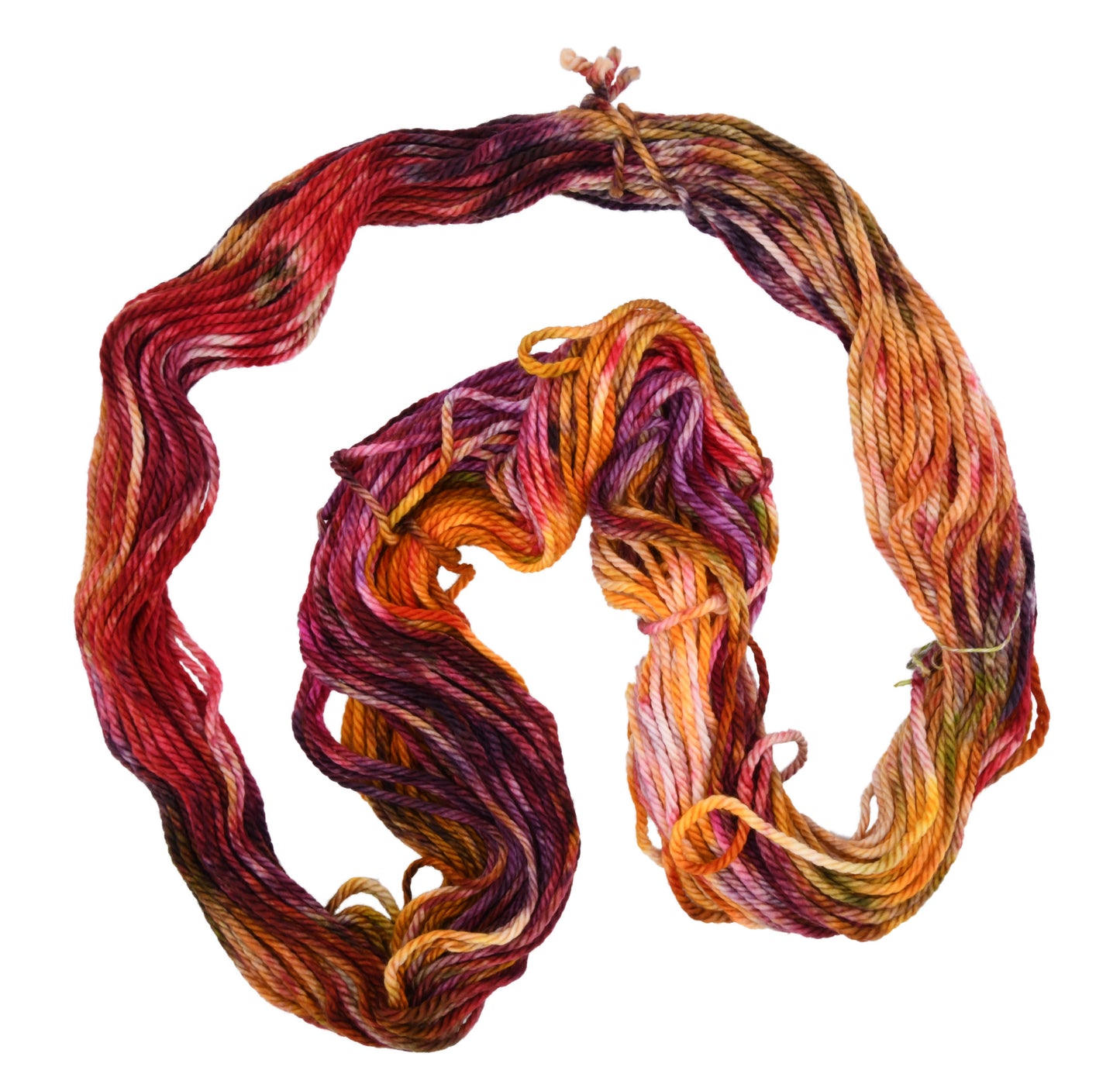 An unfolded hank of Reykjavik Hot Spot hand-dyed bulky weight yarn showing a lively mix of red, orange, salmon pink, sage green, and deep aubergine, perfect for vibrant handmade creations.