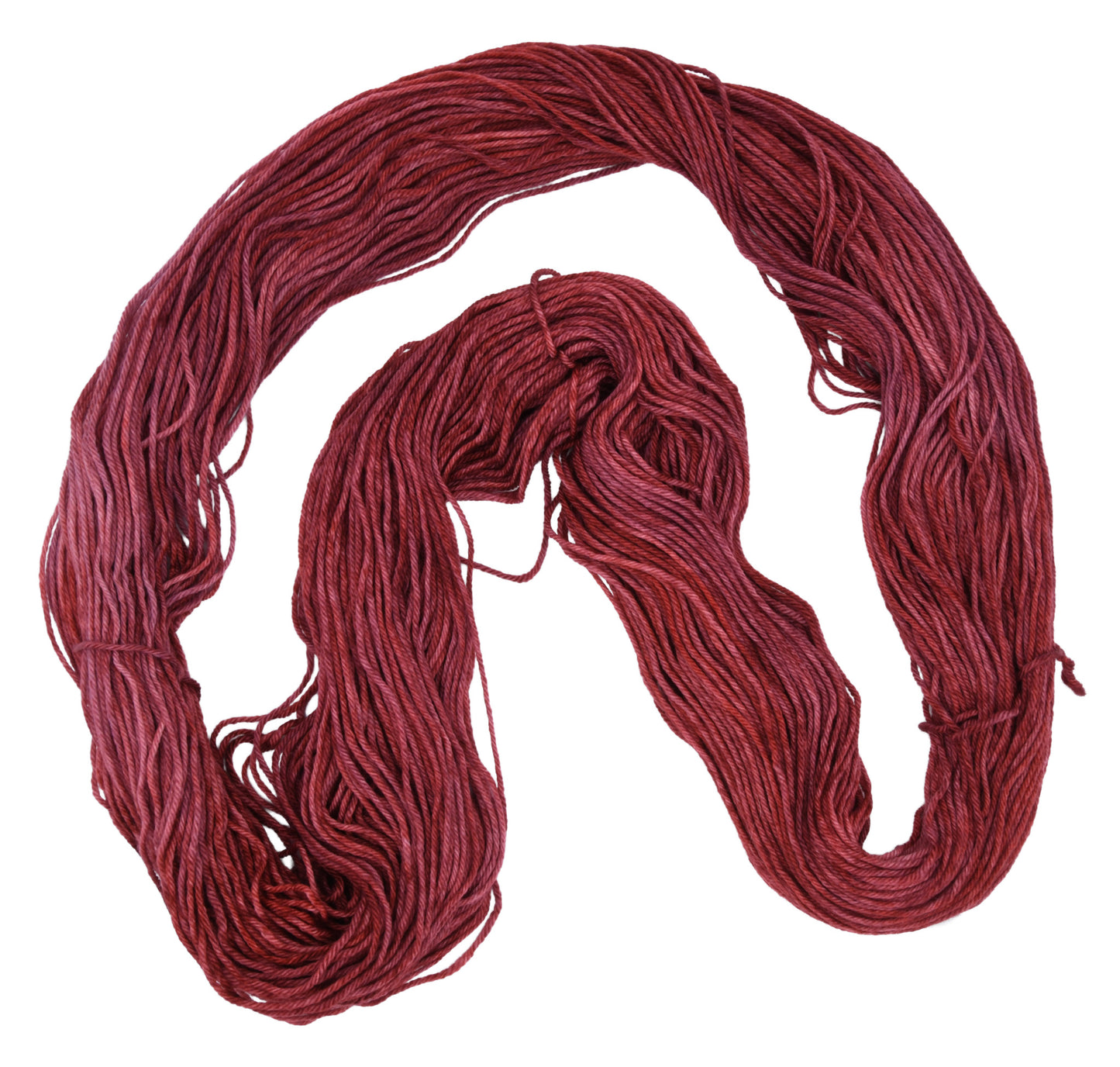 Unfolded hank of Wine Rose marino-cashmere-nylon (MCN) yarn — richly dyed in a romantic dark rose color, showcasing the depth and tonal variation of the hand-dyed fiber.