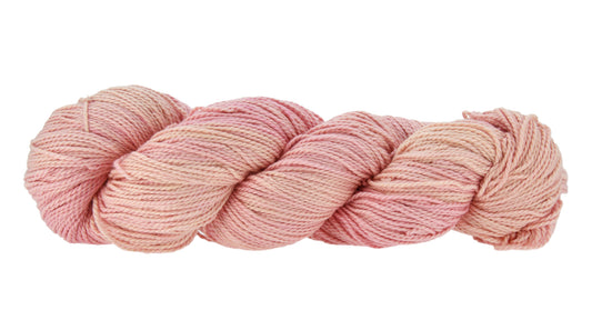 Hand-dyed DK weight yarn in Himalayan Salt colorway — 100% Pima cotton skein in a soft blend of pink and peach tones, twisted in a classic hank to show smooth 2-ply construction and subtle color shifts