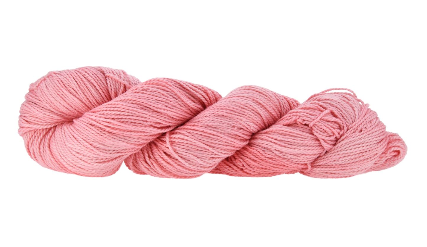 Hand-dyed DK weight yarn in My Job is Beach colorway — 100% Pima cotton skein in soft, warm pink with delicate tonal shifts, twisted in a classic hank to show smooth 2-ply texture