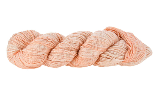 Hand-dyed DK weight yarn in Son of a Peach colorway — 100% Pima cotton skein in soft, peachy tones with warm undertones, twisted in a classic hank to highlight smooth 2-ply texture
