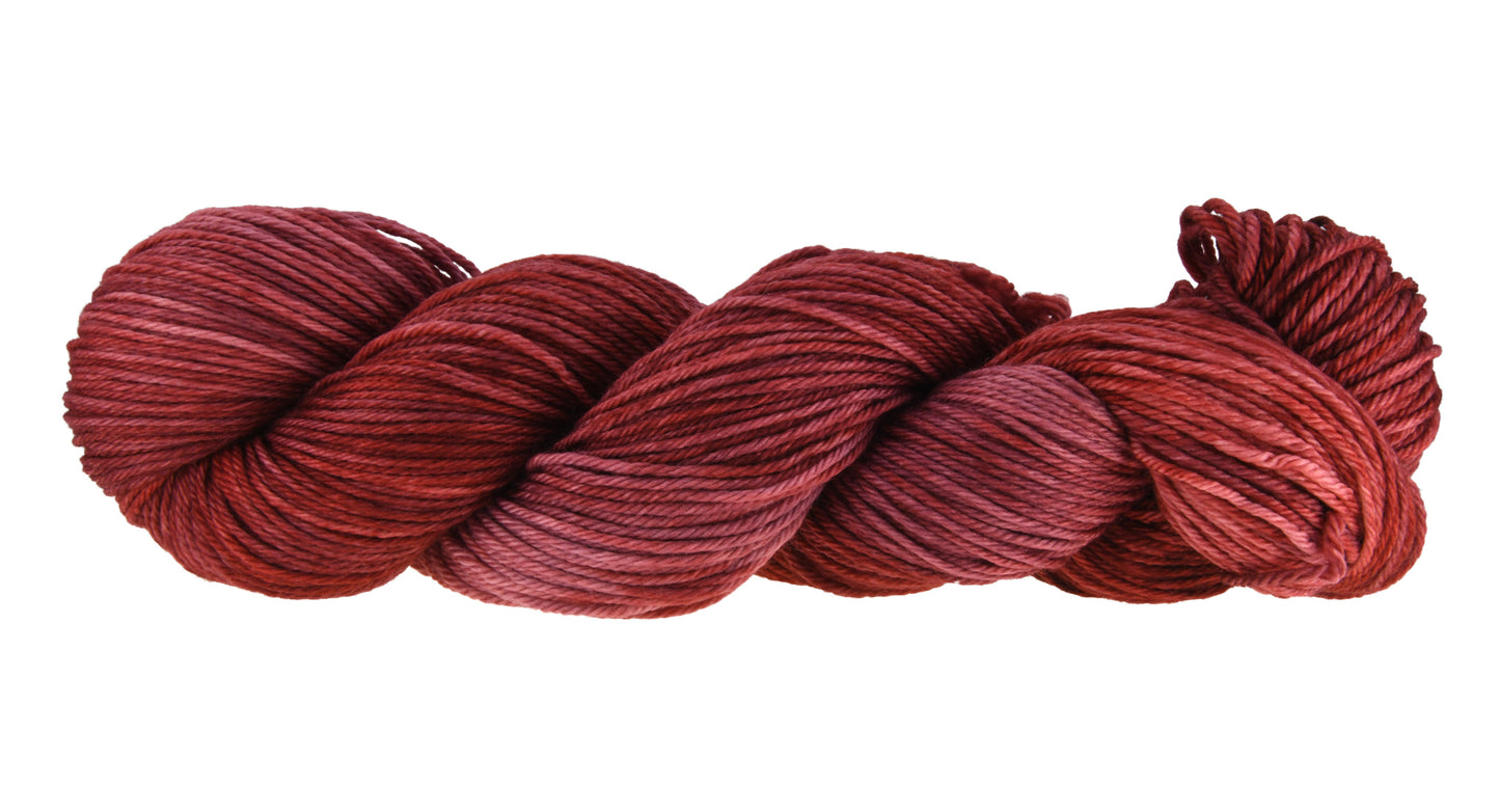 Wine Rose hand-dyed marino-cashmere-nylon (MCN) yarn in a deep rose shade, shown in a twisted hank to emphasize its tonal richness and smooth texture.