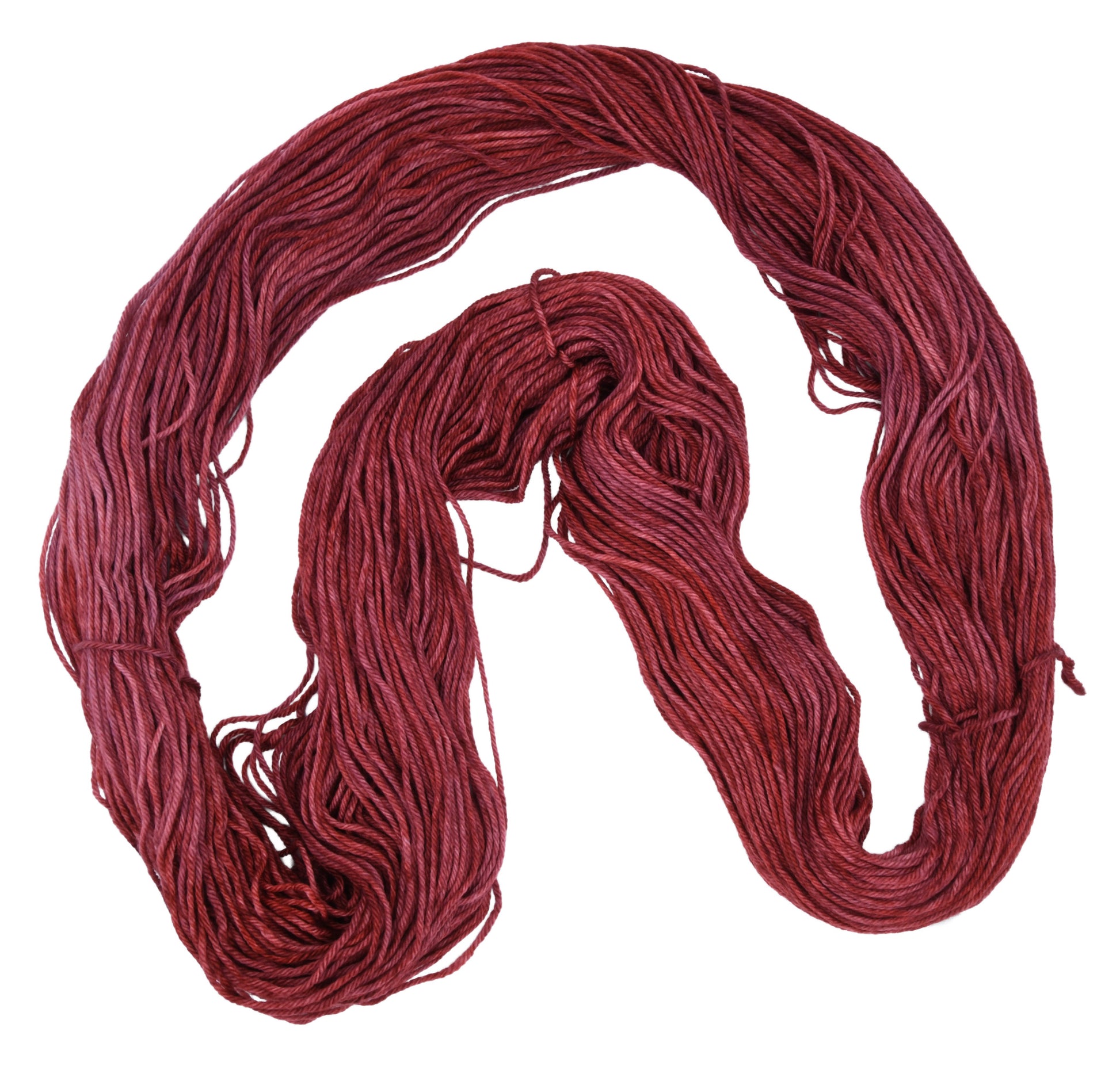 Unfolded hank of Wine Rose marino-cashmere-nylon (MCN) yarn — richly dyed in a romantic dark rose color, showcasing the depth and tonal variation of the hand-dyed fiber.