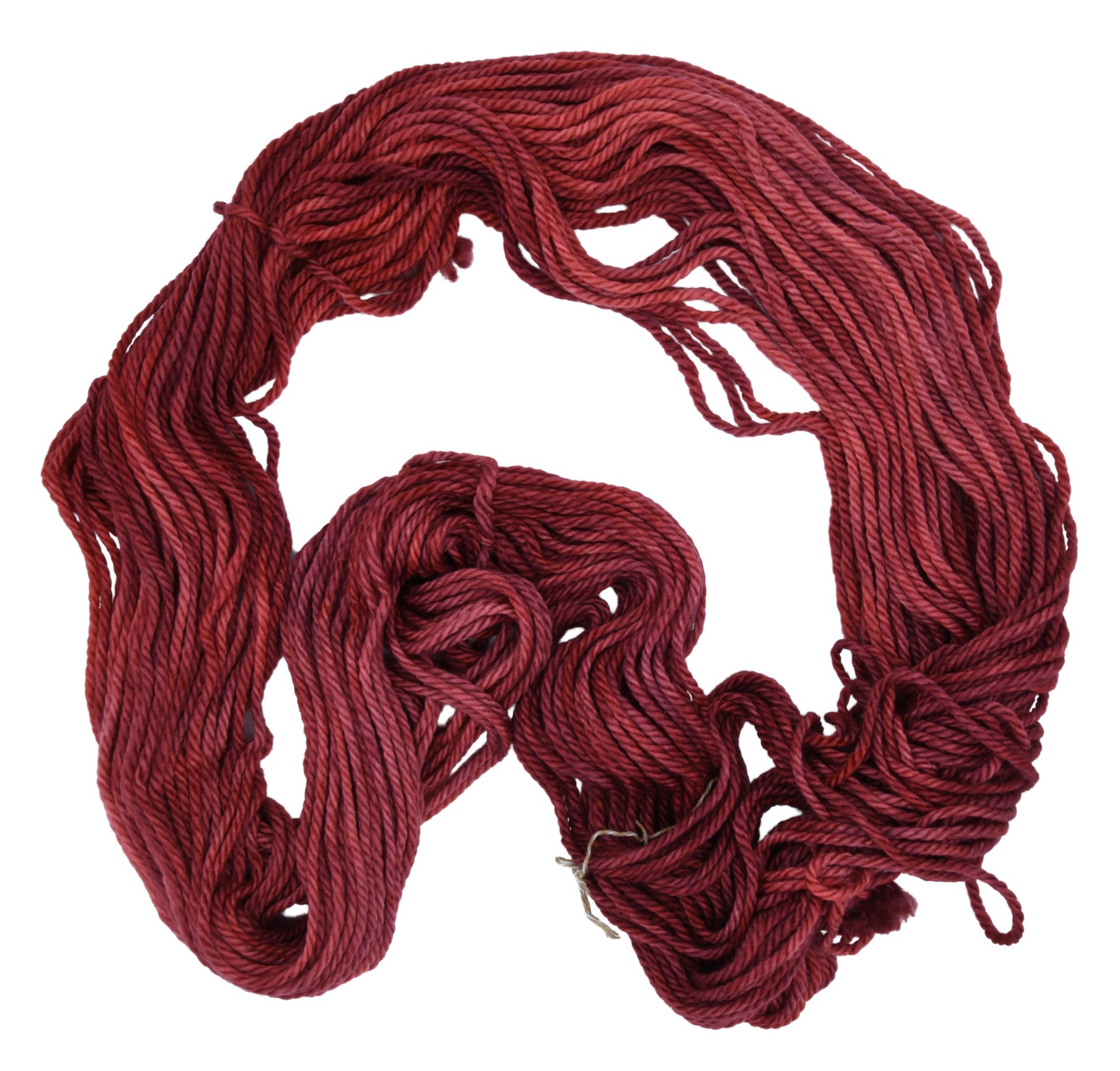Unfolded hank of Wine Rose bulky weight yarn — richly dyed in a romantic dark rose color, showcasing the depth and tonal variation of the hand-dyed fiber.