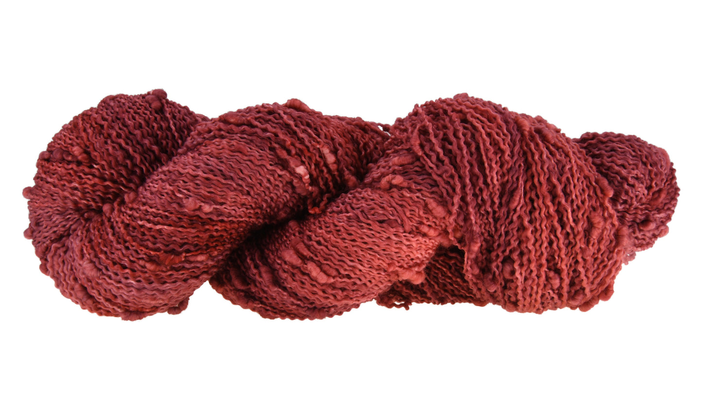Wine Rose hand-dyed slub yarn in a deep rose shade, shown in a twisted hank to emphasize its tonal richness and amazing texture.