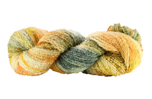 Winter Pumpkin Boucle Yarn — hand-dyed in soft sage green and apricot with gold speckles, shown in a twisted hank that emphasizes the slub texture and earthy tonal blend