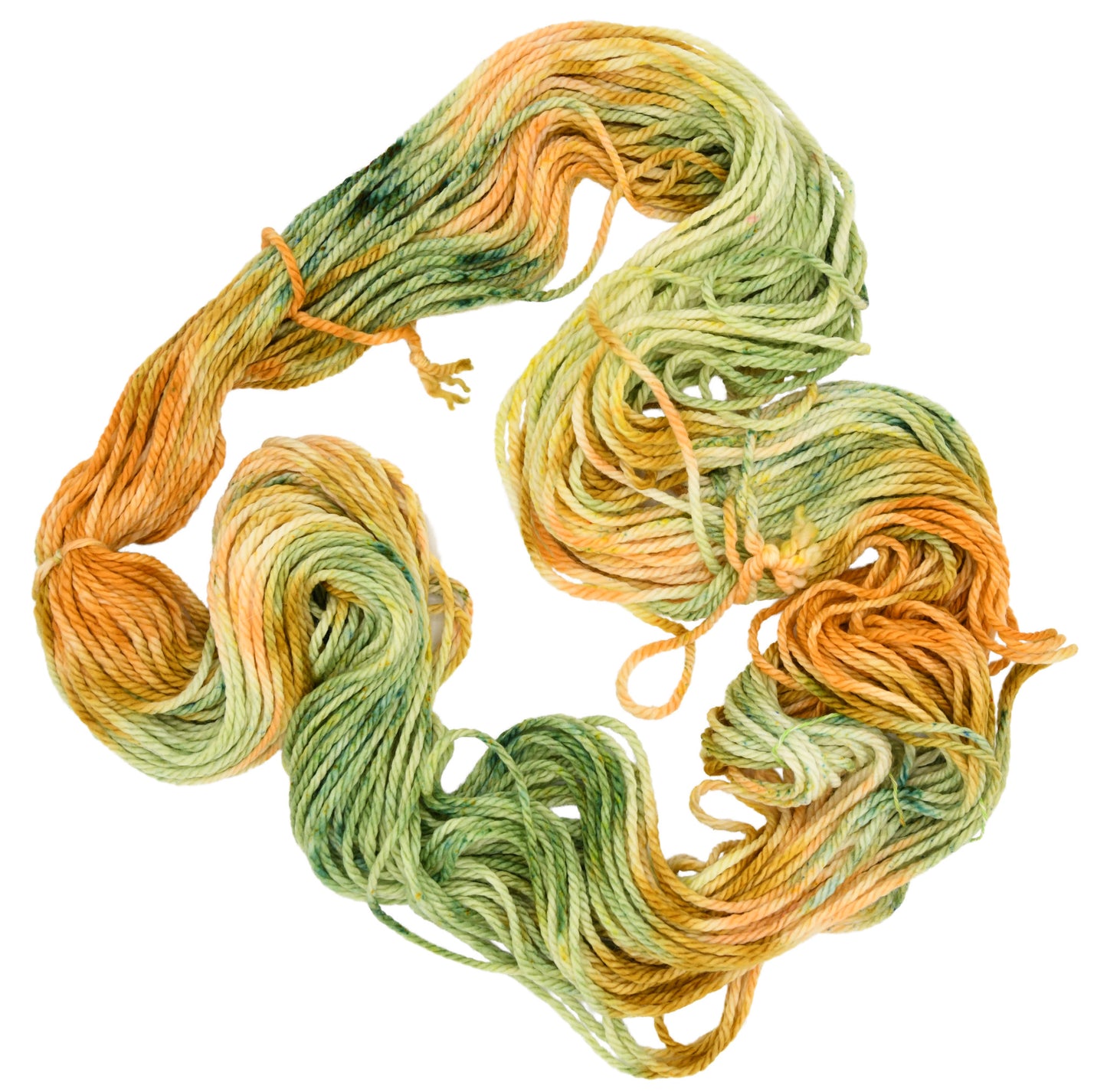 Unfolded hank of Winter Pumpkin Bulky weight yarn — a mix of sage, apricot, and golden speckles, highlighting the playful texture and subtle color shifts