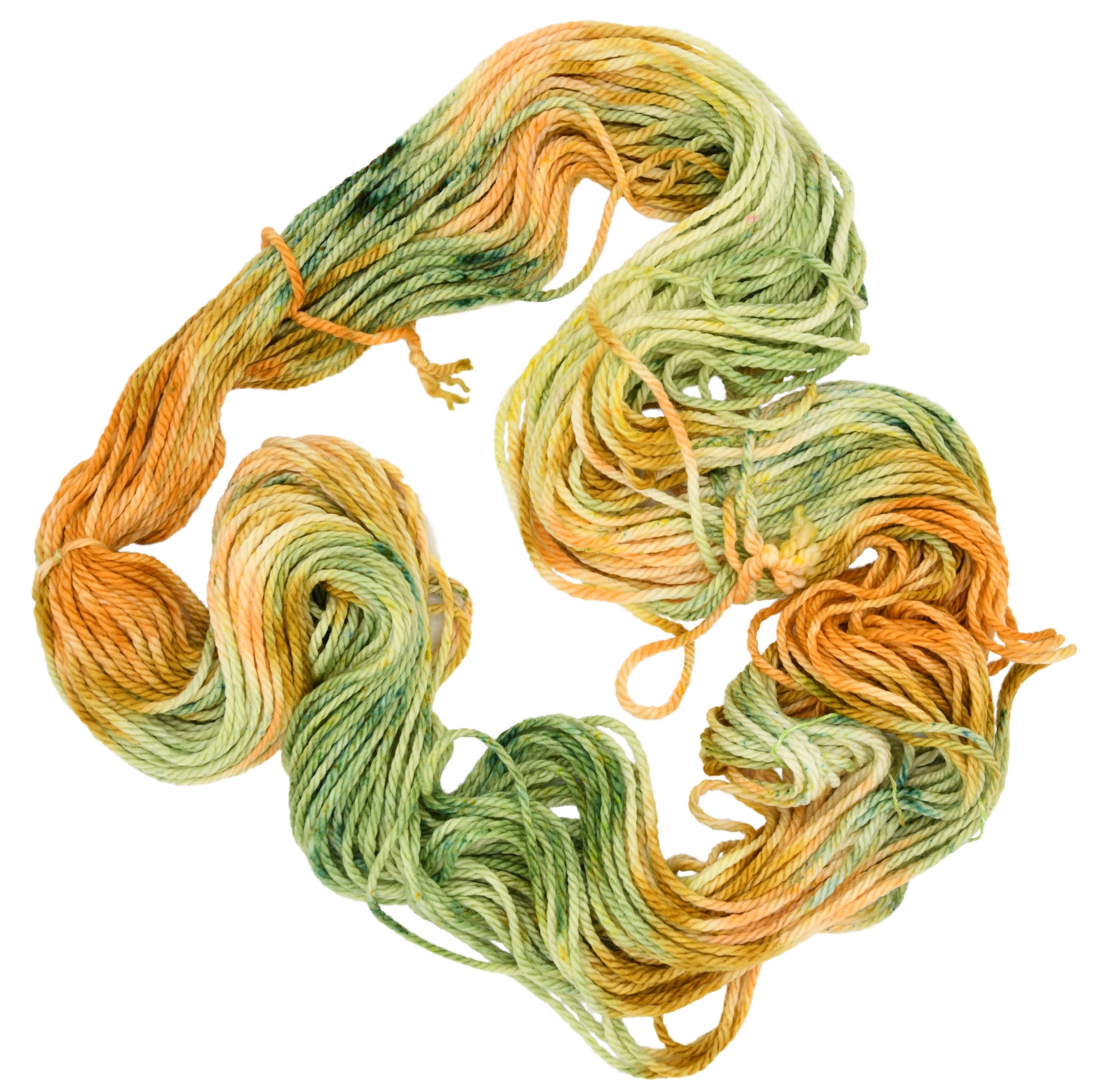 Unfolded hank of Winter Pumpkin Bulky weight yarn — a mix of sage, apricot, and golden speckles, highlighting the playful texture and subtle color shifts