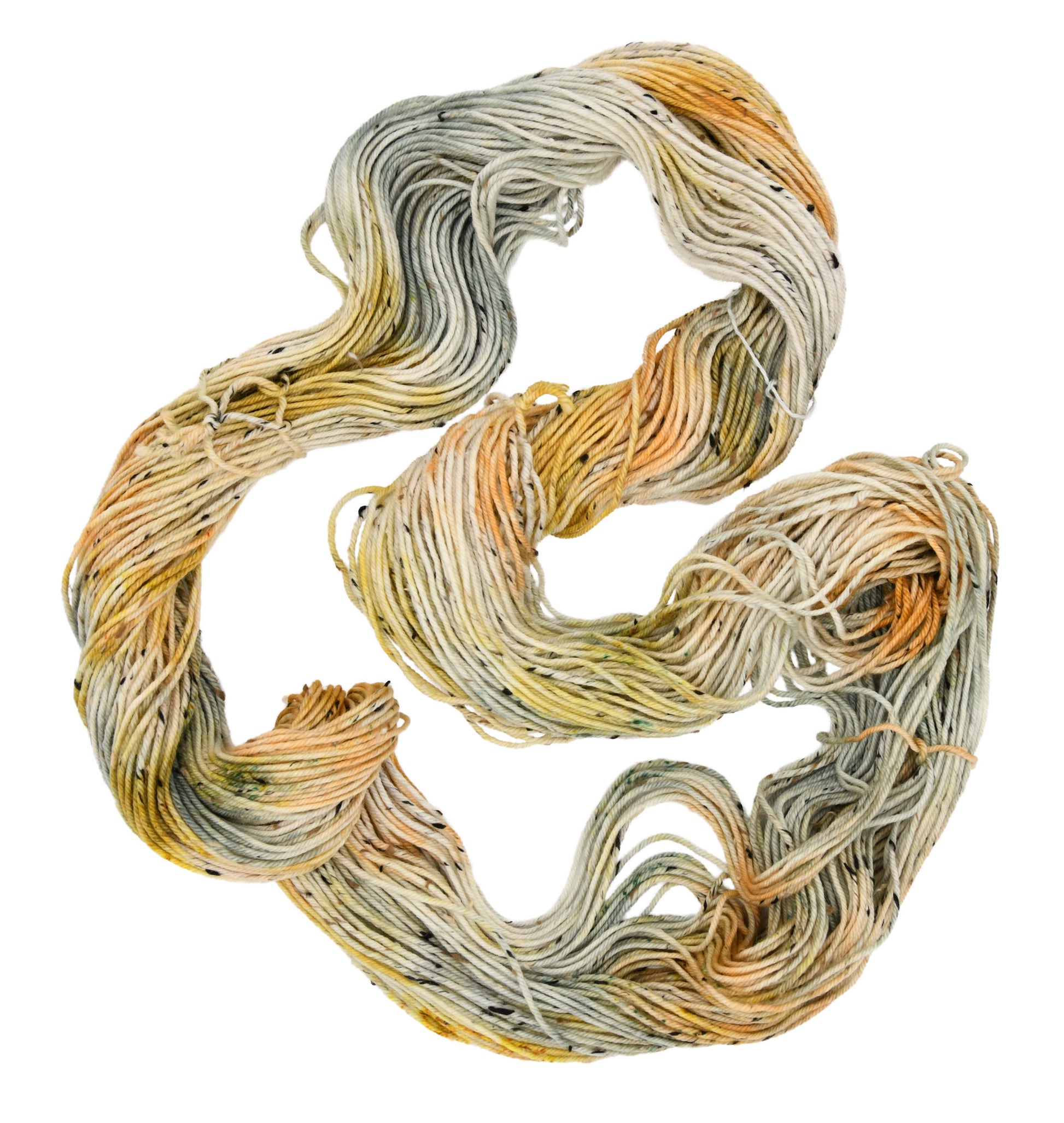 Unfolded hank of Winter Pumpkin Tweed yarn —  a mix of sage, apricot, and golden speckles, highlighting the playful texture and subtle color shifts
