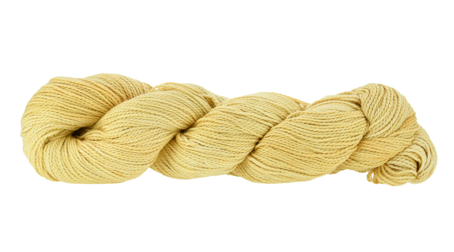 Hand-dyed DK weight yarn in Zen Garden colorway — 100% Pima cotton skein in soft yellow with subtle tonal shifts, twisted in a classic hank to show smooth 2-ply structure and gentle sheen