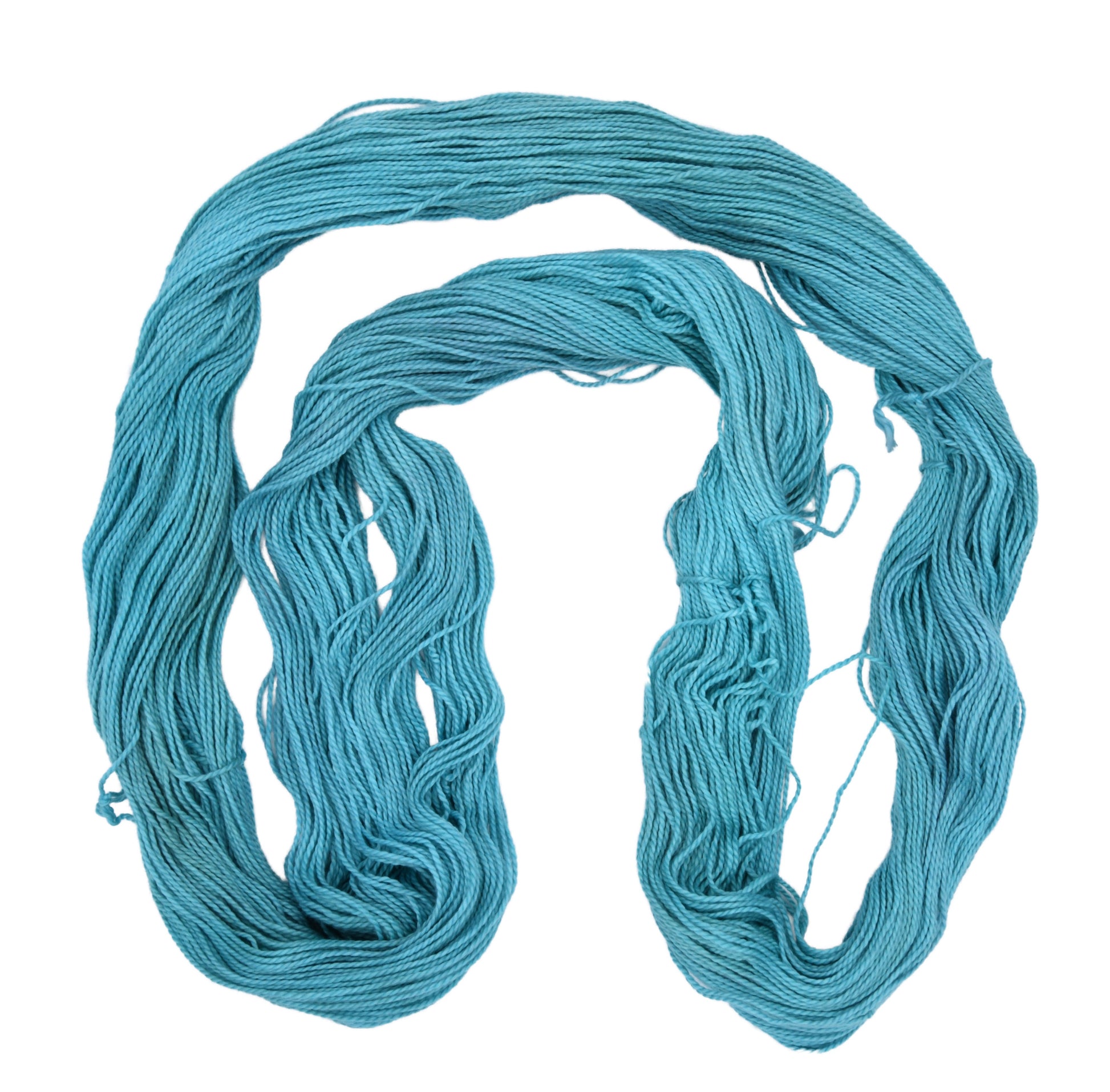Unfolded hank of Barn Yarn hand-dyed 100% cotton DK weight yarn in colorway Teal the Cows Come Home — rich deep teal, perfect for all knit and crochet projects.