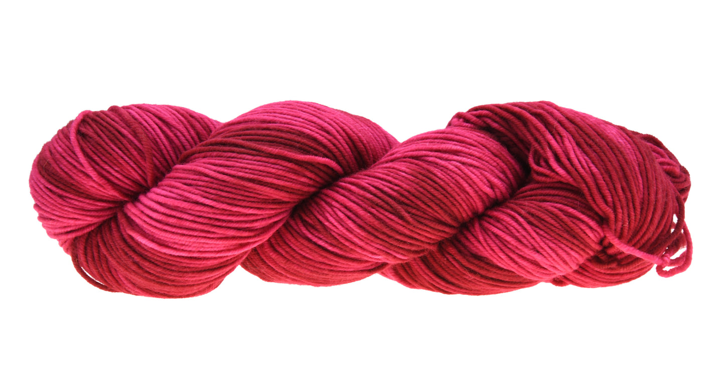 A twisted hank of DK weight hand-dyed yarn in colorway Pomegranate featuring layered bright and dark saturated pink tones, ideal for vibrant handmade creations.