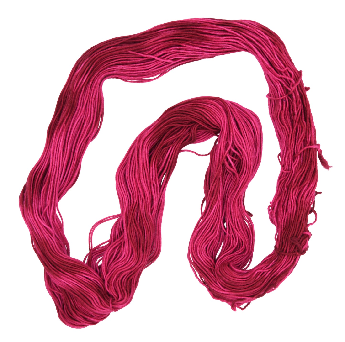 An unfolded hank of DK weight hand-dyed yarn in colorway Pomegranate featuring layered bright and dark saturated pink tones, ideal for vibrant handmade creations.
