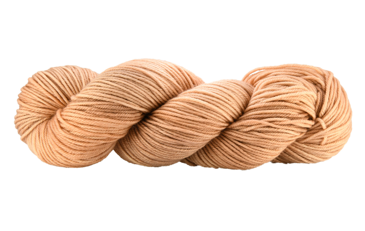 A twisted skein of Barn Yarn hand-dyed DK weight yarn in colorway Pink Sand, a soft blush pink with sandy undertones, perfect for knitting and crochet projects.