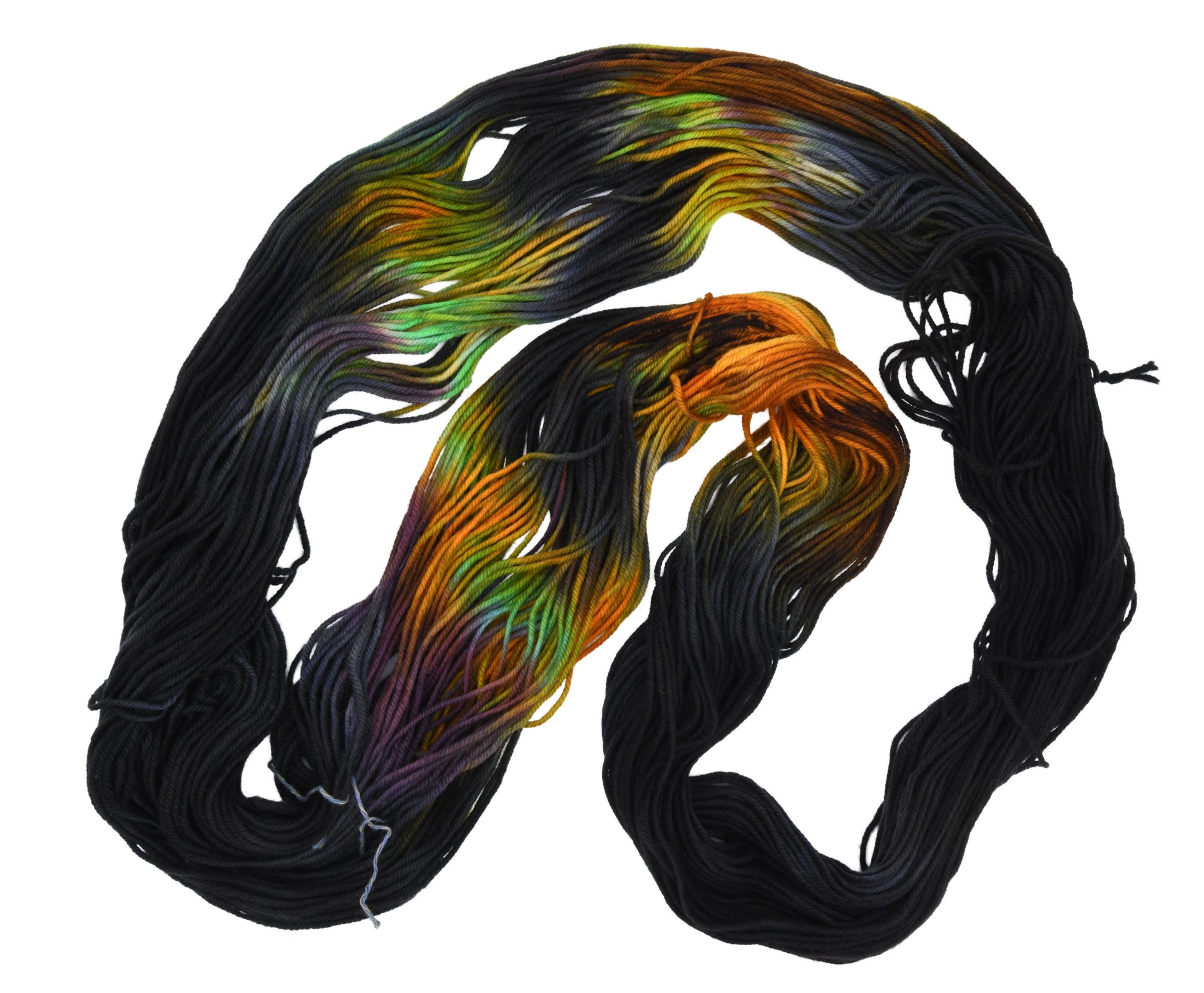 An unfolded skein of Barn Yarn hand-dyed DK weight yarn in colorway Imperial Pumpkin - a black base layered with pumpkin orange, plum, blue, gray, green, and warm browns. Perfect for knitting and crochet projects.
