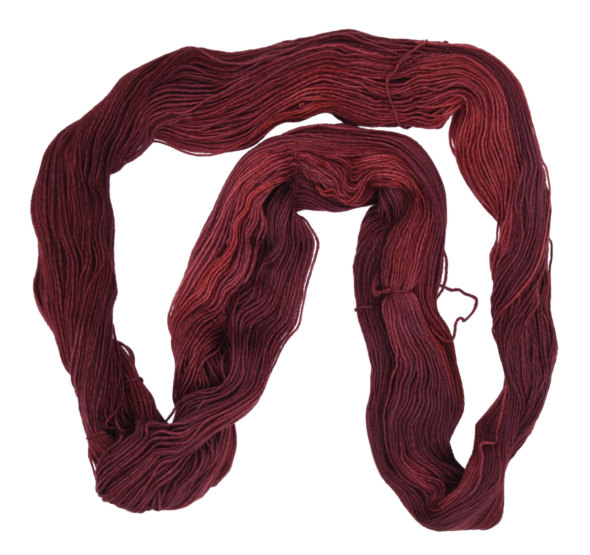 An unfolded skein of Barn Yarn hand-dyed fingering weight yarn in colorway Chocolate Moose; a rich, earthy brown shade, perfect for warm and cozy knitting and crochet projects.