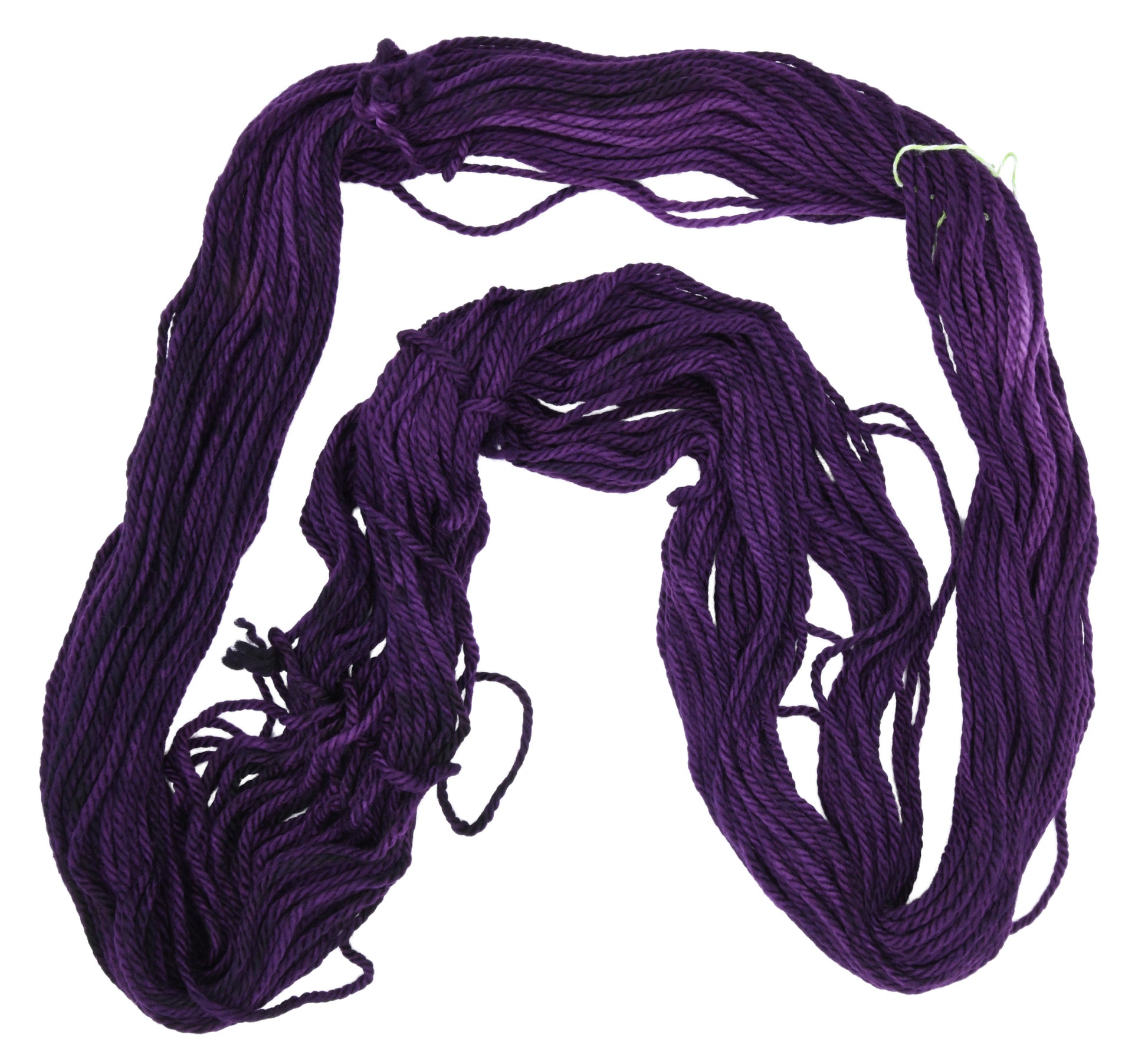 An unfolded hank of Barn Yarn hand-dyed bulky yarn in colorway Grape-ly Appreciated showing vivid purple tones, ideal for eye-catching knitting and crochet creations.