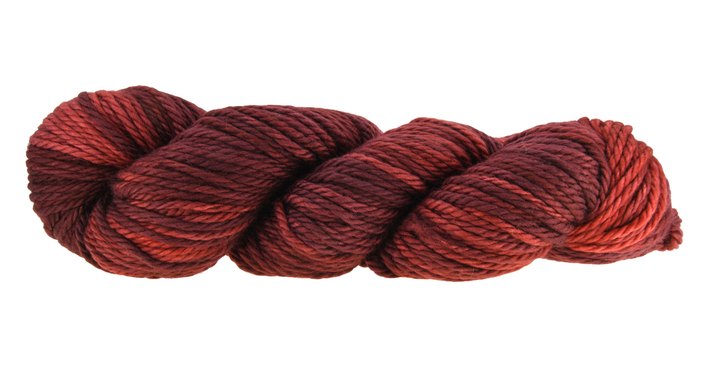 A twisted skein of Barn Yarn hand-dyed bulky weight yarn in colorway Chocolate Moose; a rich, earthy brown shade, perfect for warm and cozy knitting and crochet projects.