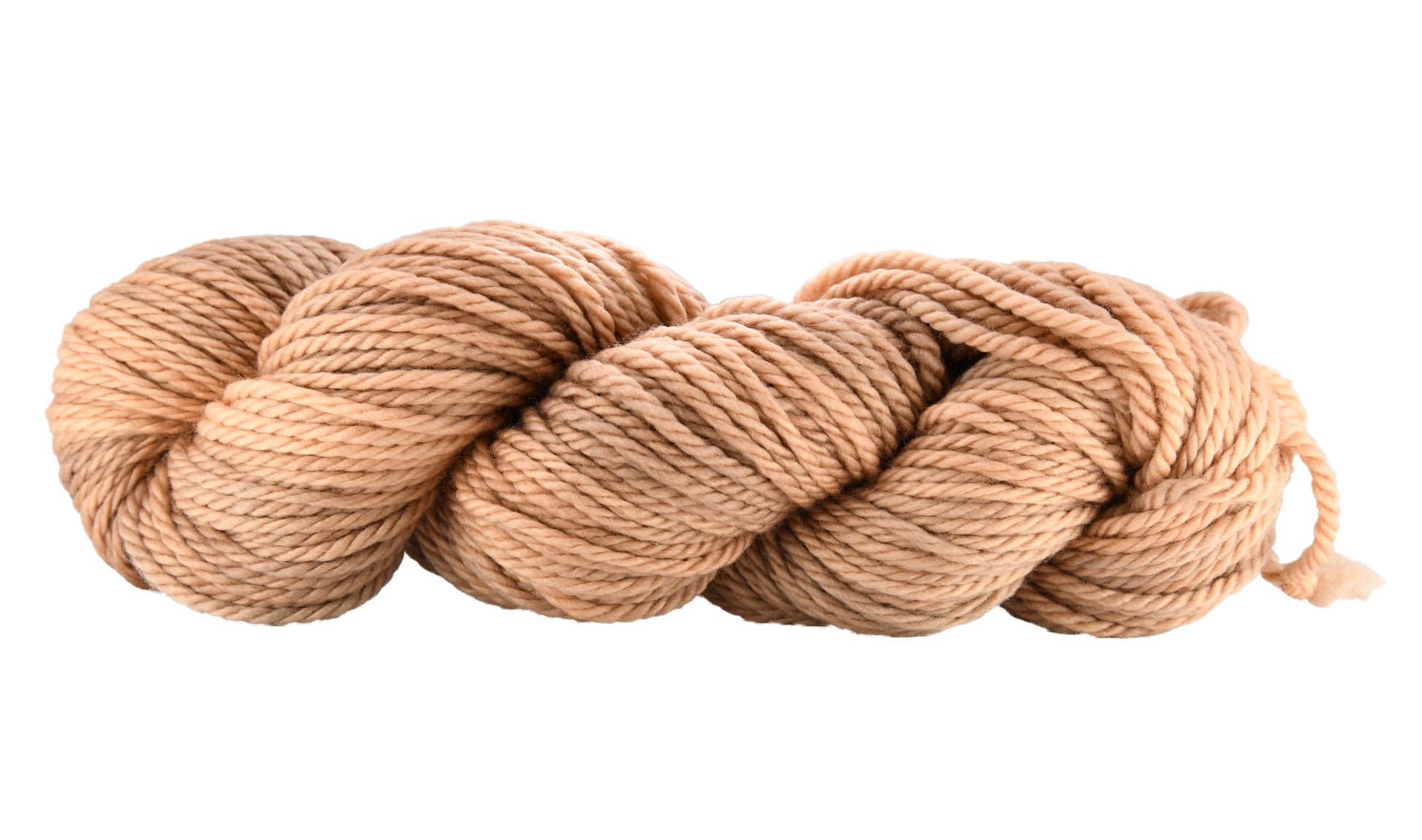 A twisted skein of Barn Yarn hand-dyed bulky weight yarn in colorway Pink Sand, a soft blush pink with sandy undertones, perfect for knitting and crochet projects.