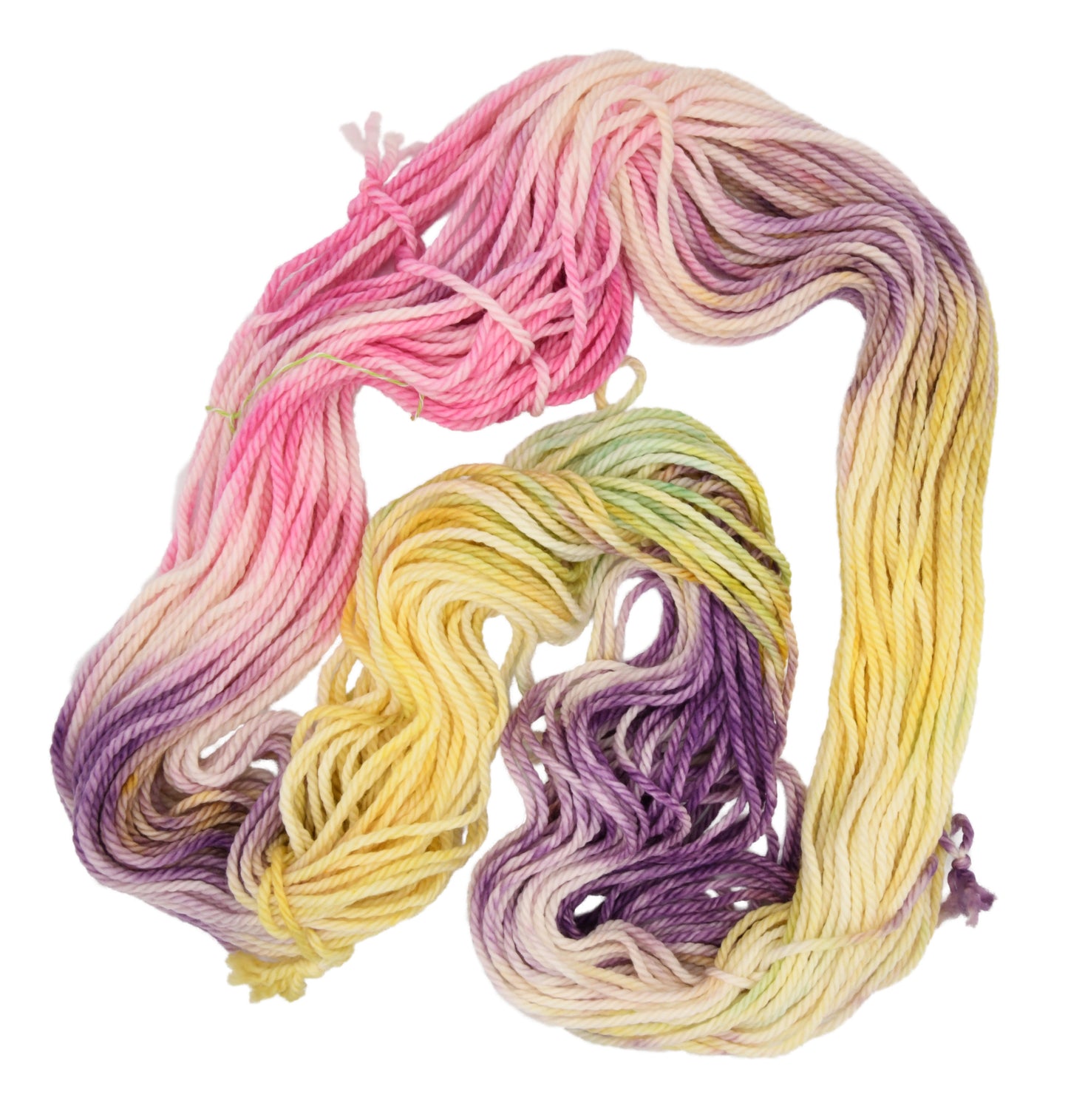 An unfolded skein of Barn Yarn hand-dyed bulky weight yarn Bubble Bath, in soft blush pinks, airy whites, and lavender hints, perfect for delicate knitting and crochet projects.