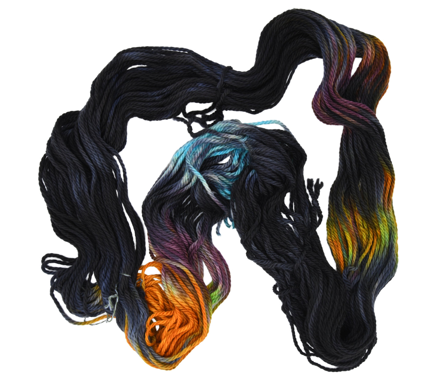 An unfolded skein of Barn Yarn hand-dyed bulky weight yarn in colorway Imperial Pumpkin - a black base layered with pumpkin orange, plum, blue, gray, green, and warm browns. Perfect for knitting and crochet projects.