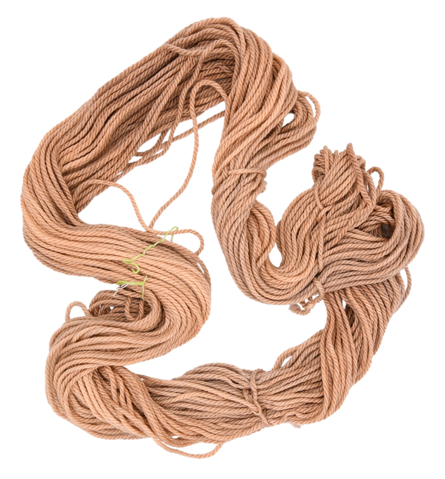 An unfolded skein of Barn Yarn hand-dyed bulky weight yarn in colorway Pink Sand, a soft blush pink with sandy undertones, perfect for knitting and crochet projects.