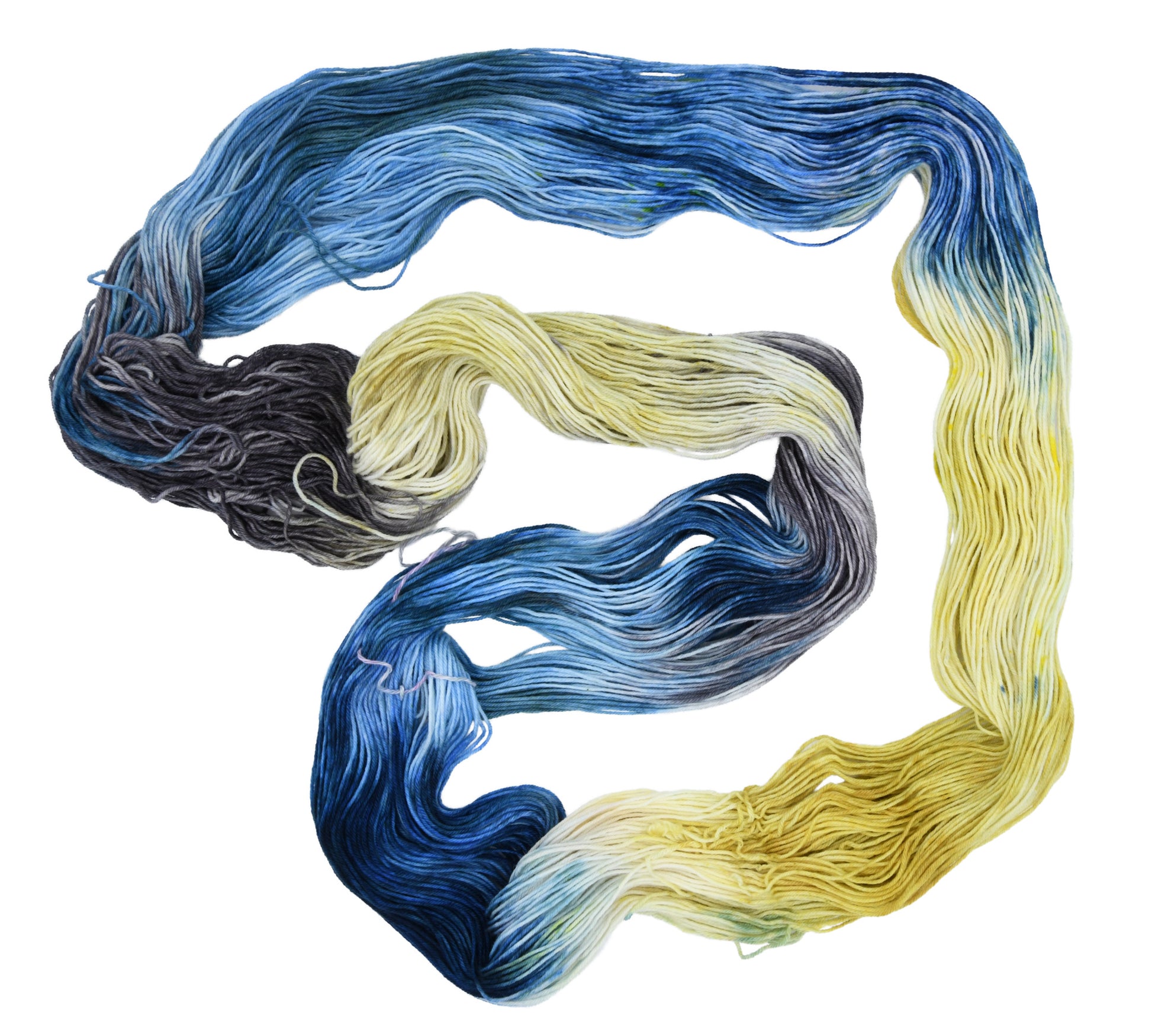 An unfolded skein of Barn Yarn hand-dyed fingering weight yarn in colorway Beehive featuring golden yellow, soft gray and blue tones, perfect for warm and vibrant knitting and crochet projects.