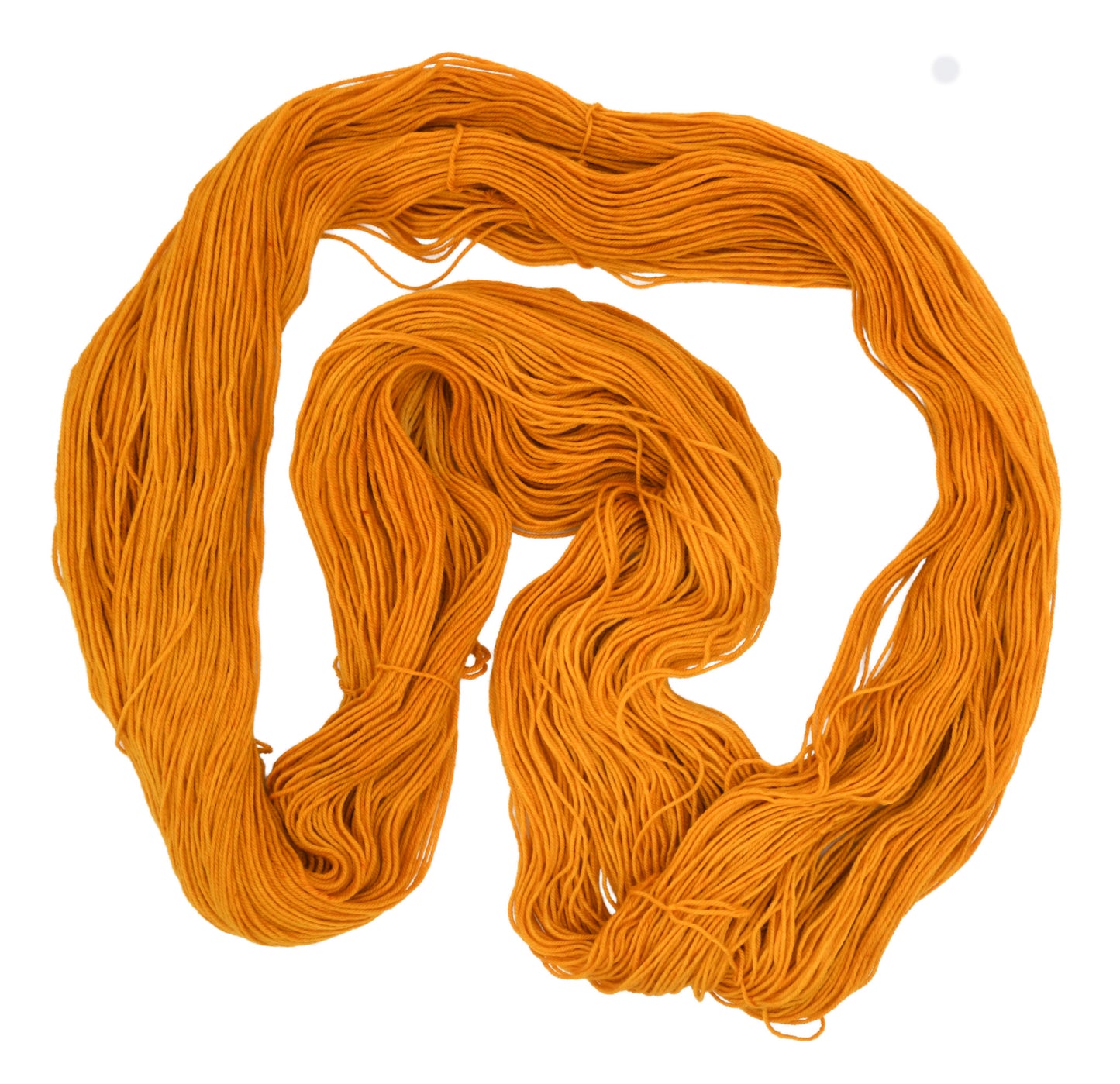 An unfolded skein of Barn Yarn hand-dyed fingering weight yarn in colorway Golden Era, a radiant golden yellow shade, perfect for warm and luxurious knitting and crochet projects.