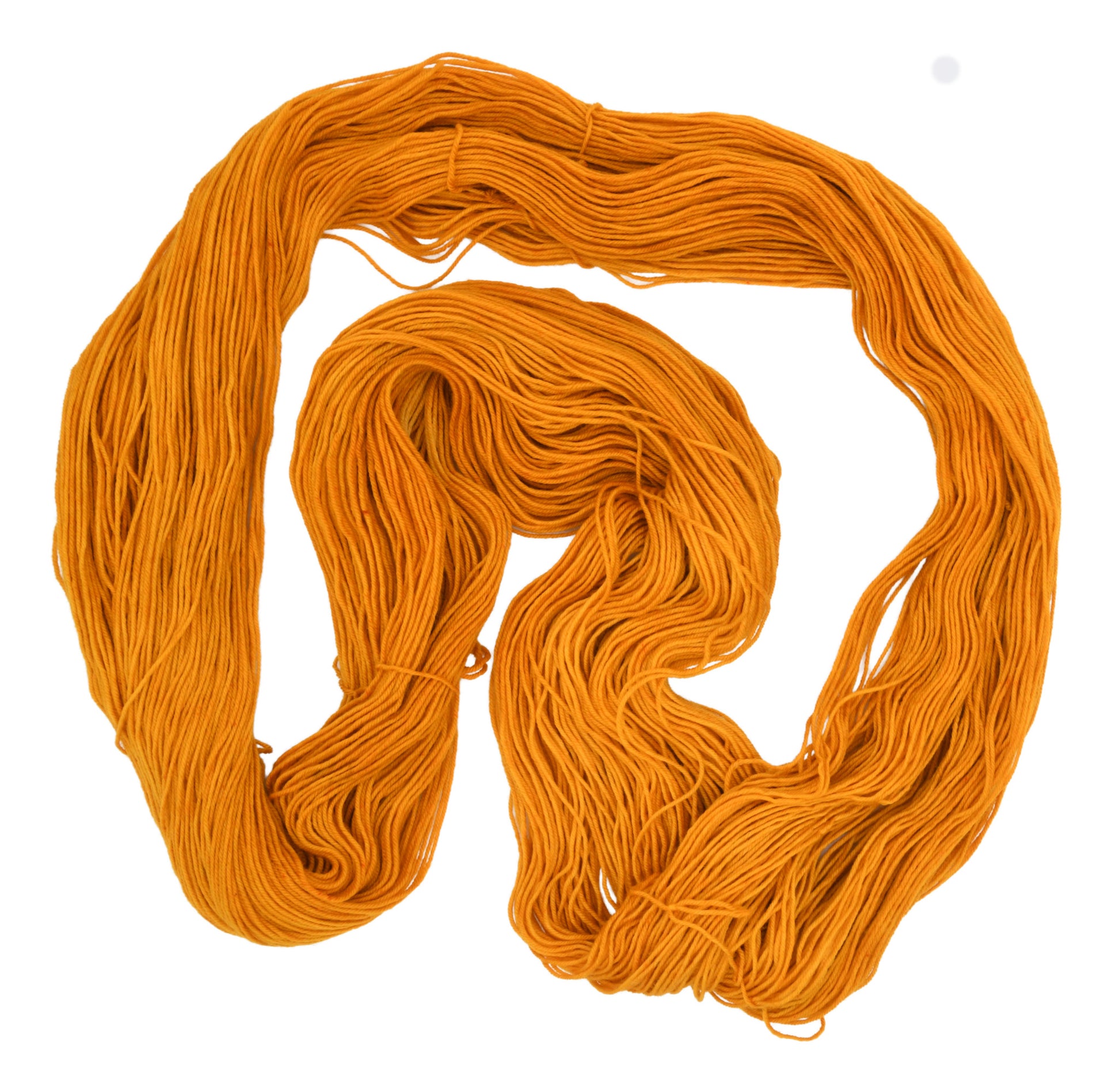 An unfolded skein of Barn Yarn hand-dyed fingering weight yarn in colorway Golden Era, a radiant golden yellow shade, perfect for warm and luxurious knitting and crochet projects.