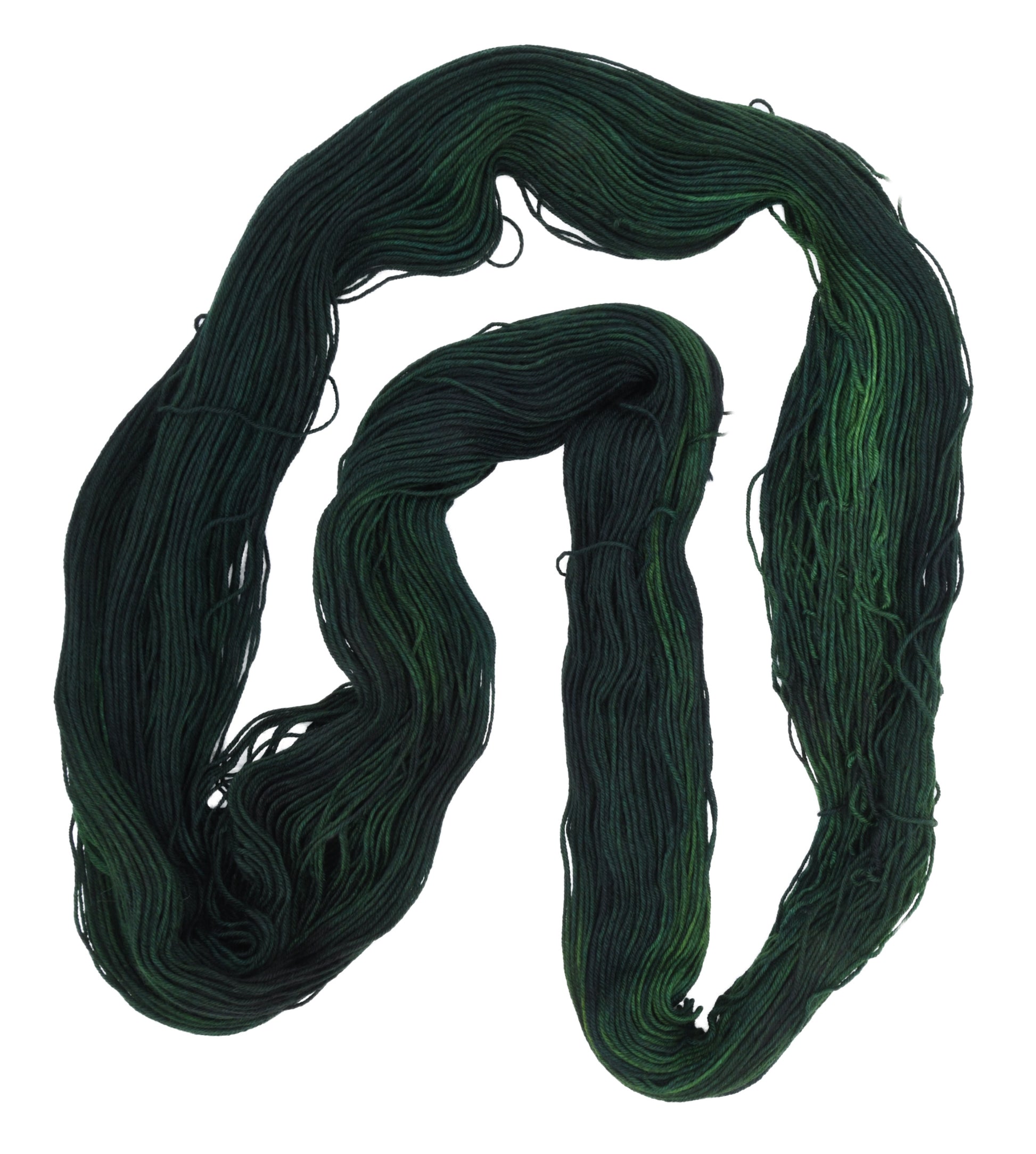 An unfolded skein of Barn Yarn hand-dyed fingering weight yarn in colorway Holly Leaves, a classic evergreen with deep, saturated tones perfect for all knit and crochet projects.