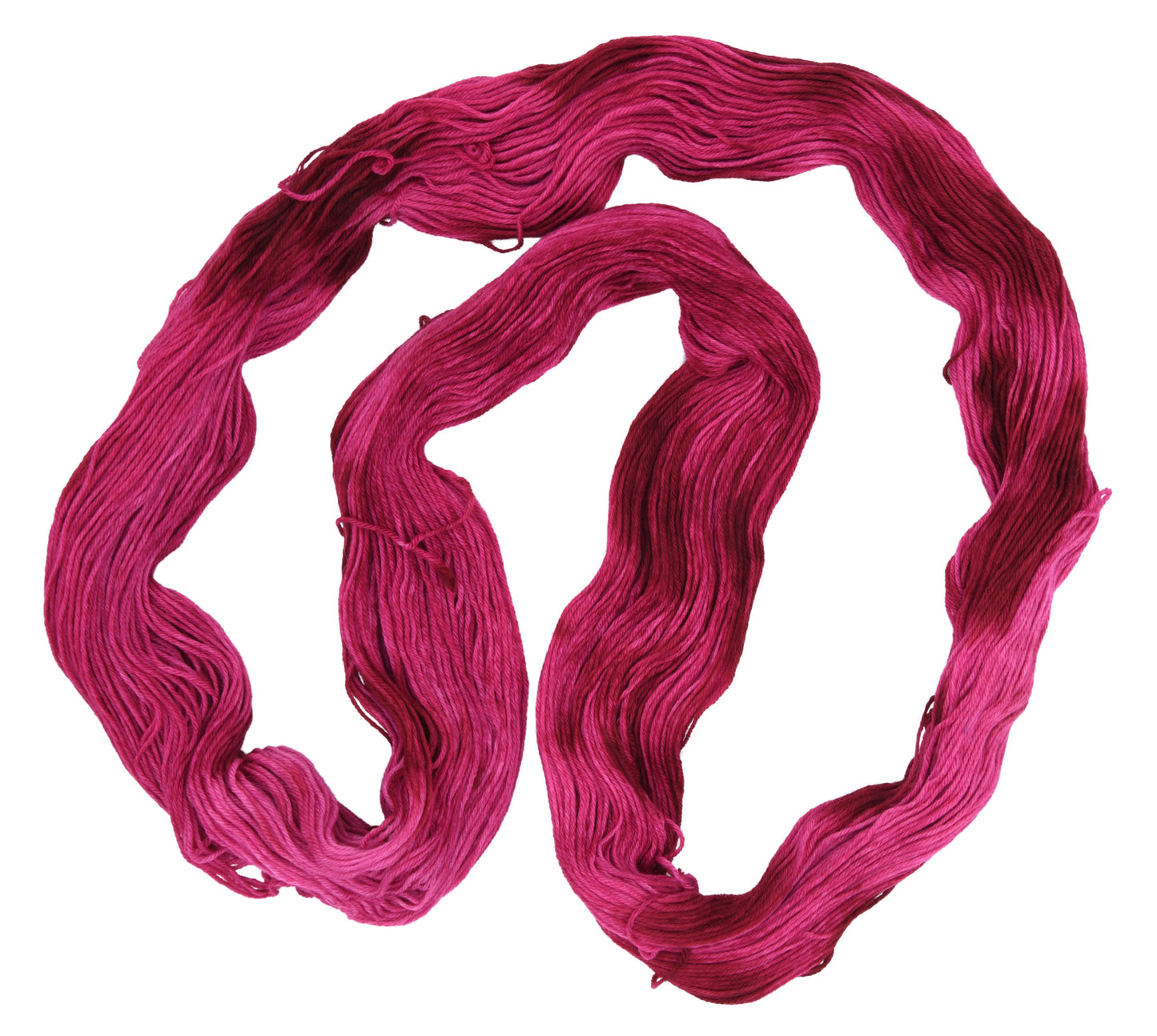 An unfolded hank of merino-cashmere-nylon-blend fingering weight hand-dyed yarn in colorway Pomegranate featuring layered bright and dark saturated pink tones, ideal for vibrant handmade creations.