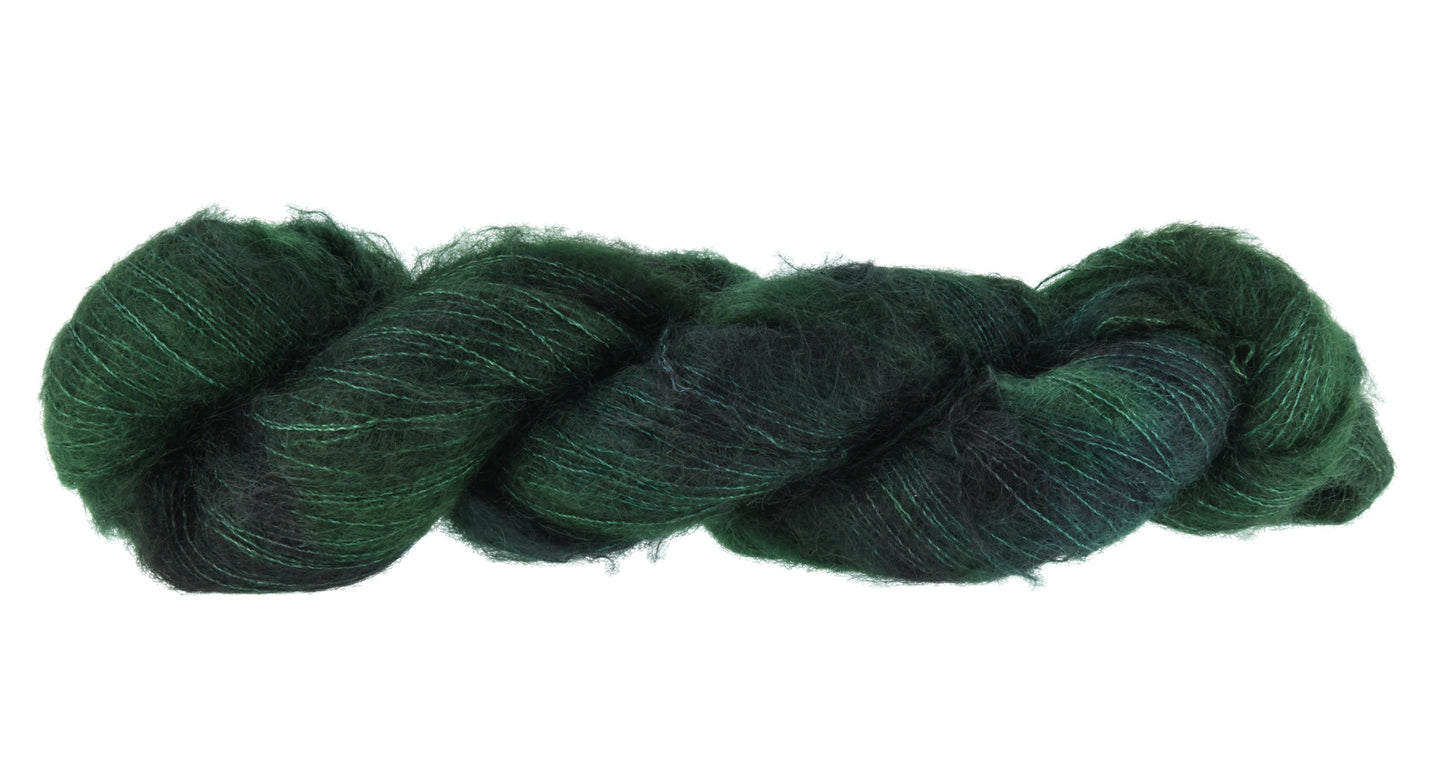 A twisted skein of Barn Yarn hand-dyed mohair yarn in colorway Holly Leaves, a classic evergreen with deep, saturated tones perfect for all knit and crochet projects.