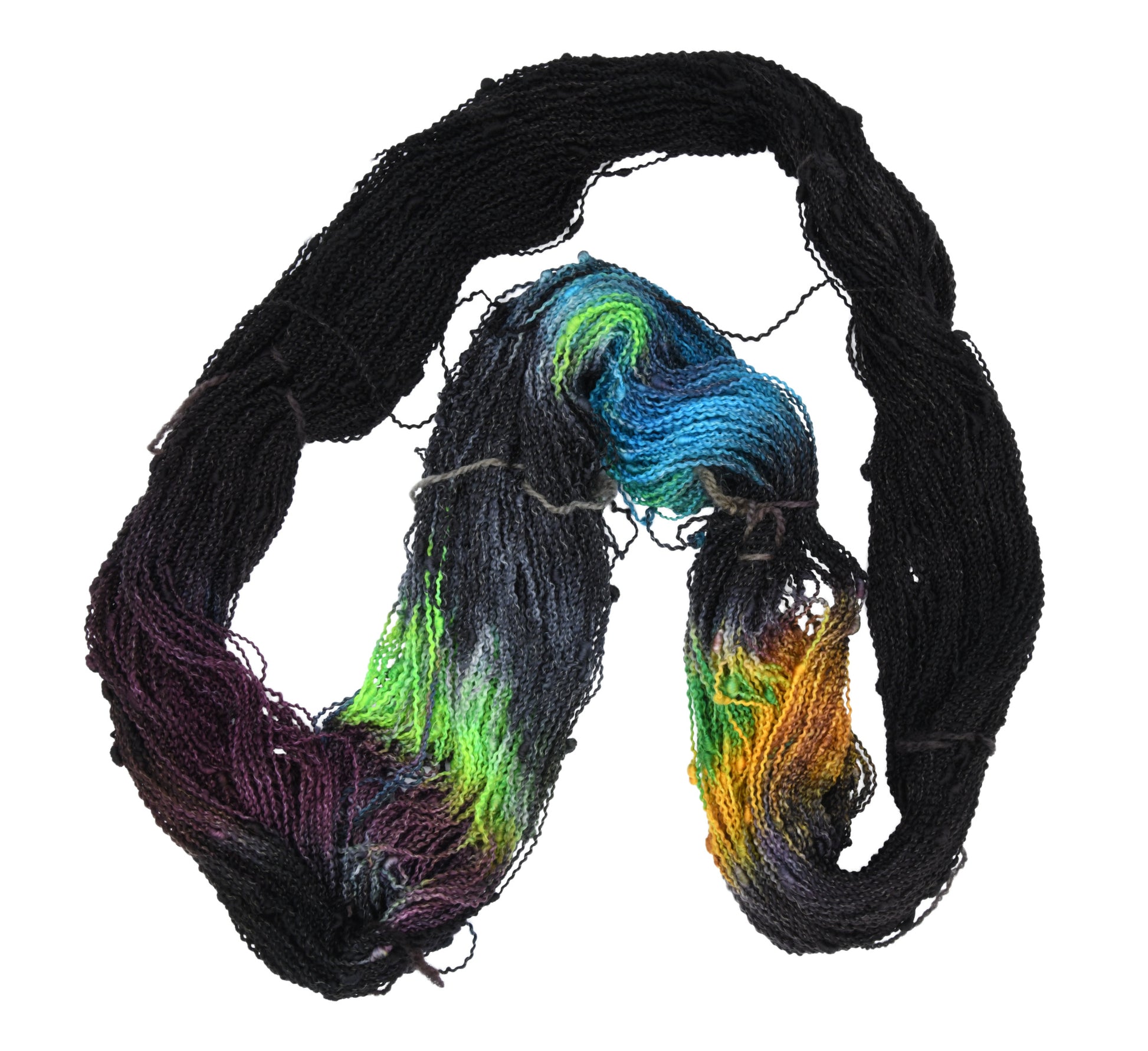 An unfolded skein of Barn Yarn hand-dyed slub yarn in colorway Imperial Pumpkin - a black base layered with pumpkin orange, plum, blue, gray, green, and warm browns. Perfect for knitting and crochet projects.