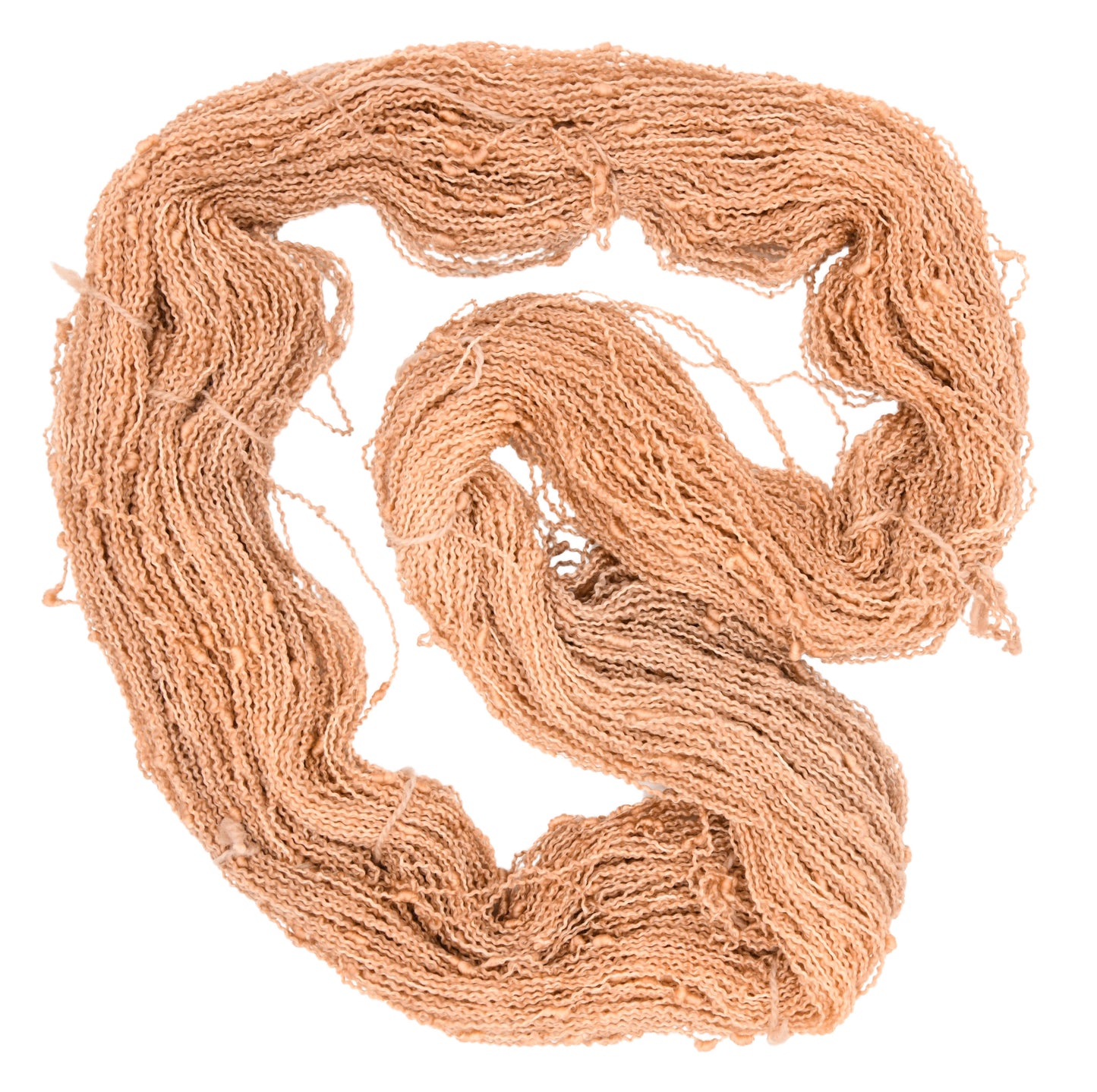 An unfolded skein of Barn Yarn hand-dyed slub yarn in colorway Pink Sand, a soft blush pink with sandy undertones, perfect for knitting and crochet projects.