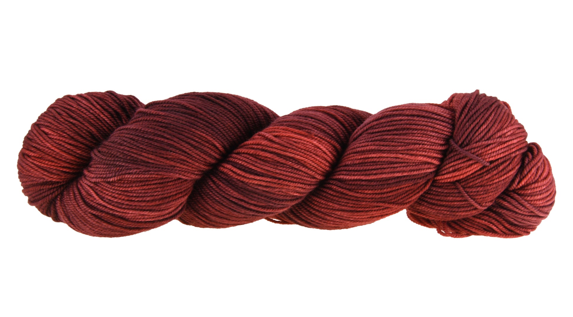 A twisted skein of Barn Yarn hand-dyed sport weight yarn in colorway Chocolate Moose; a rich, earthy brown shade, perfect for warm and cozy knitting and crochet projects.