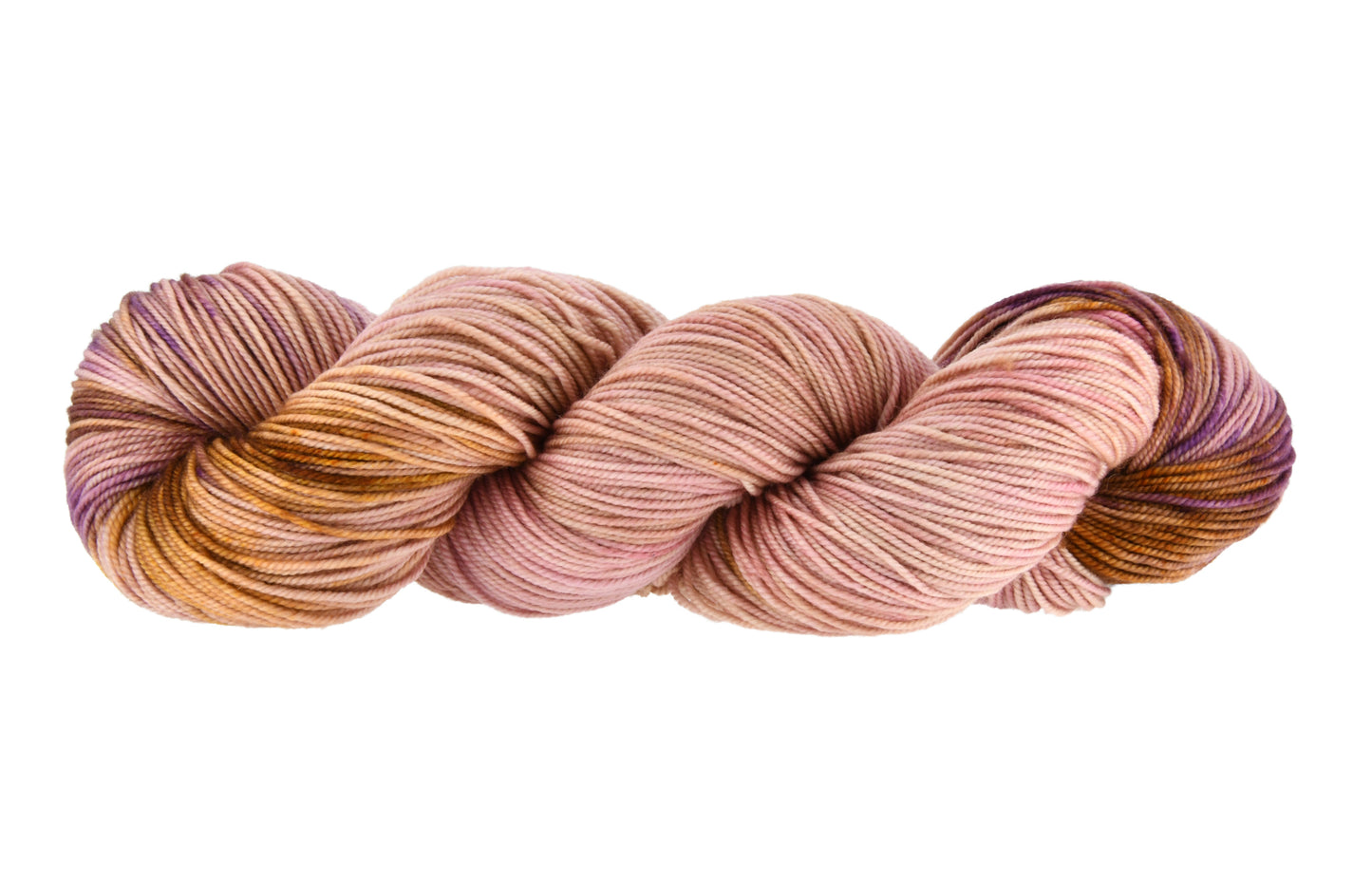 A twisted skein of Barn Yarn hand-dyed sport weight yarn in colorway Nougat, a light pink, toffee, and purple combination, perfect for knitting and crochet projects.
