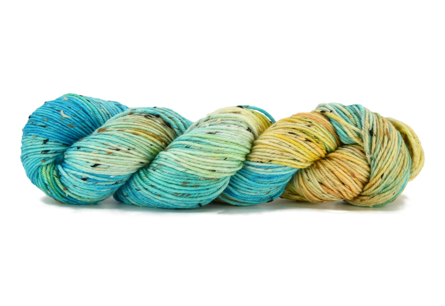 A twisted skein of Barn Yarn hand-dyed tweed DK weight yarn in colorway Down by the Seaside with breezy blues, sandy neutrals, and sea-glass greens, perfect  knitting and crochet.