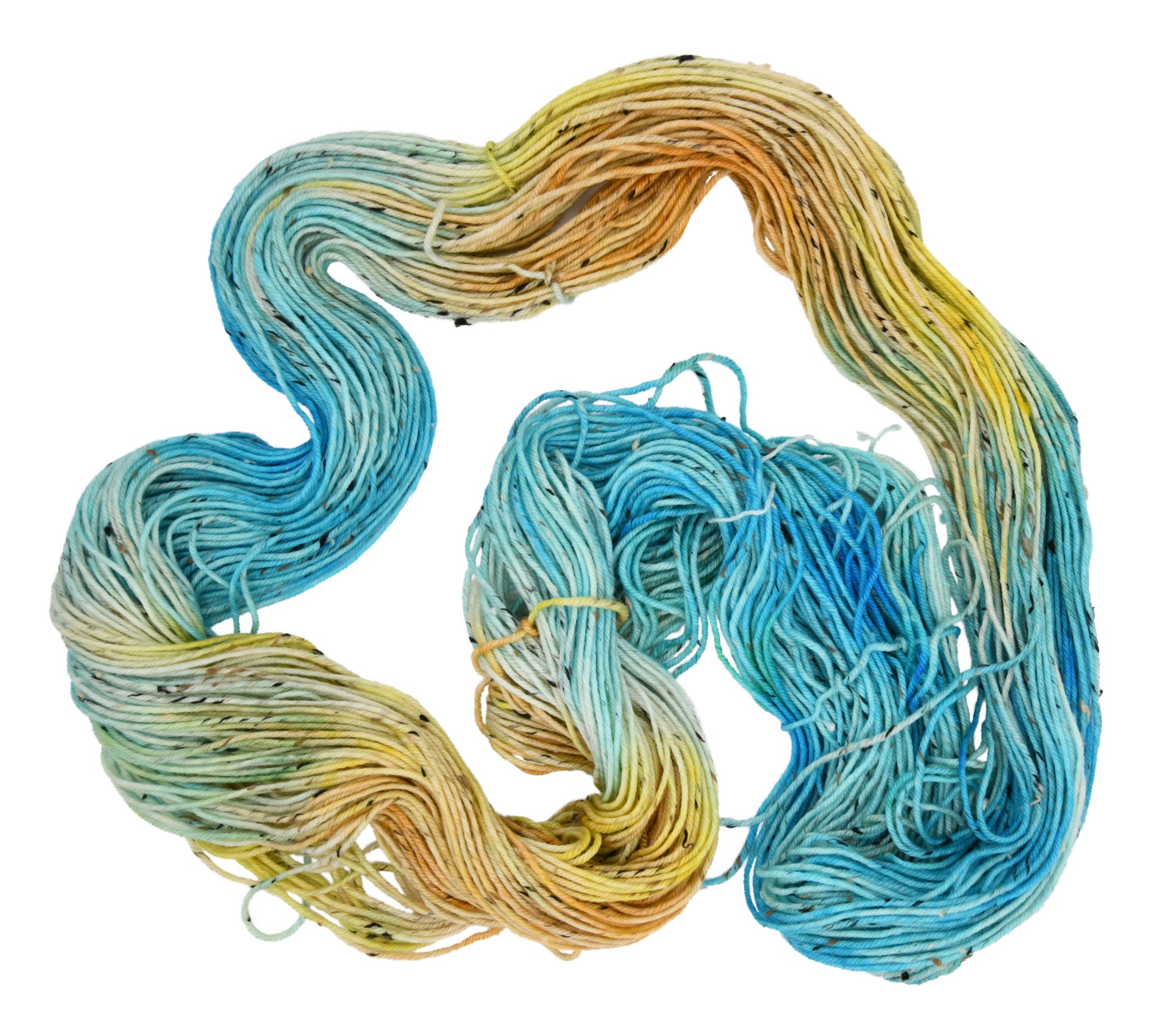 An unfolded skein of Barn Yarn hand-dyed tweed DK weight yarn in colorway Down by the Seaside with breezy blues, sandy neutrals, and sea-glass greens, perfect  knitting and crochet.