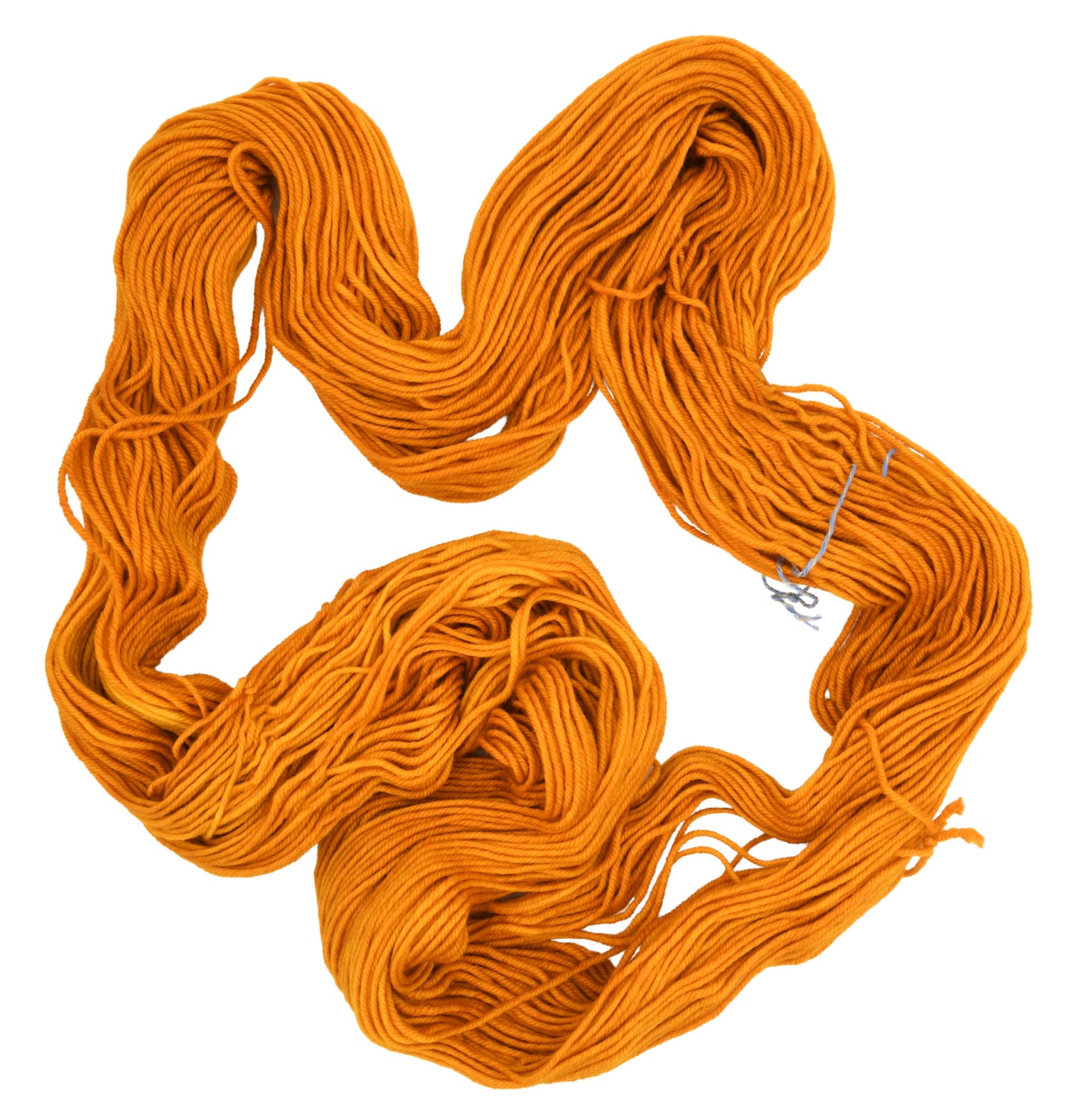 An unfolded skein of Barn Yarn hand-dyed worsted weight yarn in colorway Golden Era, a radiant golden yellow shade, perfect for warm and luxurious knitting and crochet projects.
