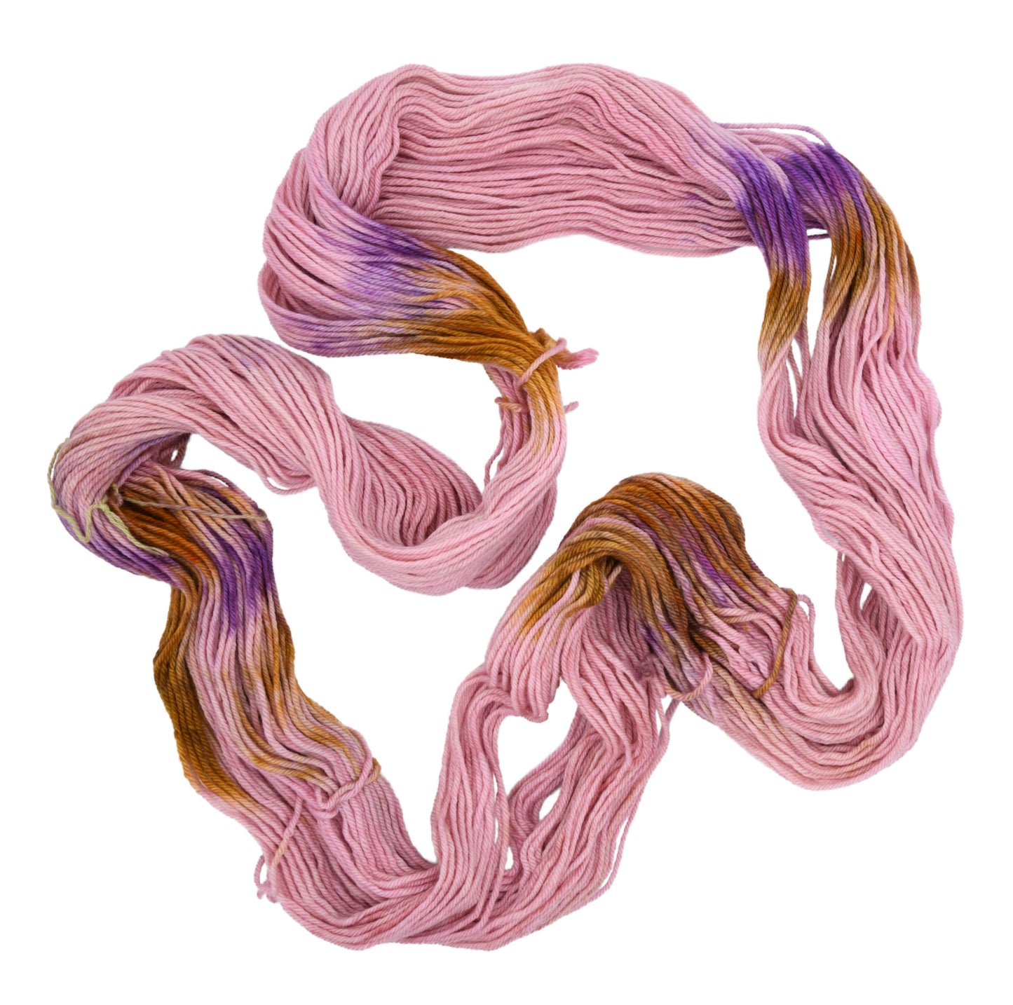 An unfolded skein of Barn Yarn hand-dyed worsted weight yarn in colorway Nougat, a light pink, toffee, and purple combination, perfect for knitting and crochet projects.