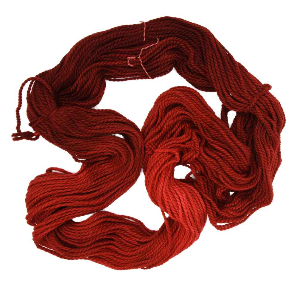 An unfolded skein of Barn Yarn hand-dyed bulky weight yarn in colorway Chili Pepper, a vibrant, spicy red, perfect for bold and cozy knitting and crochet projects.